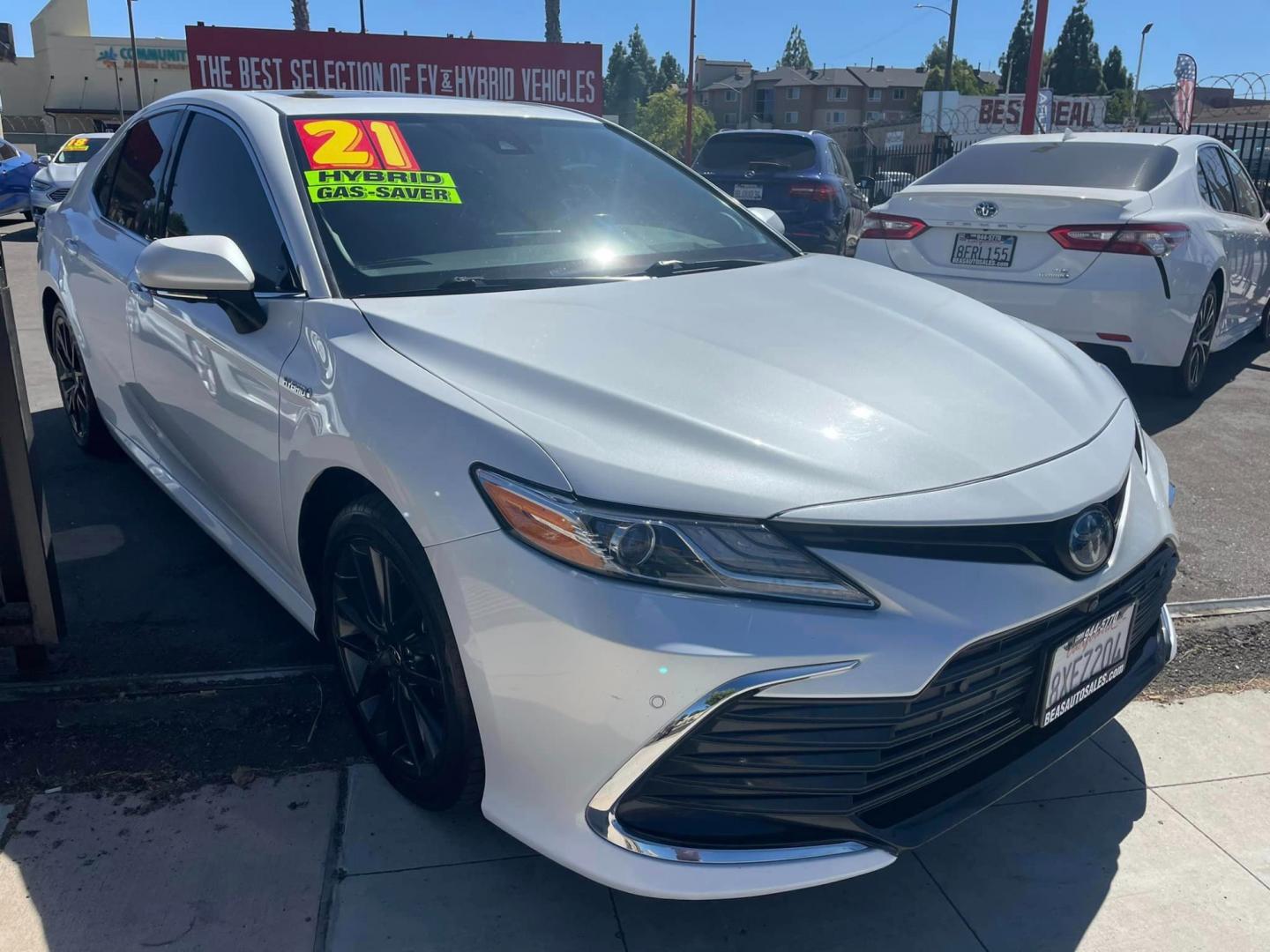 2021 WHITE /BLACK Toyota Camry Hybrid XLE (4T1F31AK2MU) with an 2.5L L4 DOHC 16V HYBRID engine, CVT transmission, located at 744 E Miner Ave, Stockton, CA, 95202, (209) 944-5770, 37.956863, -121.282082 - Photo#0